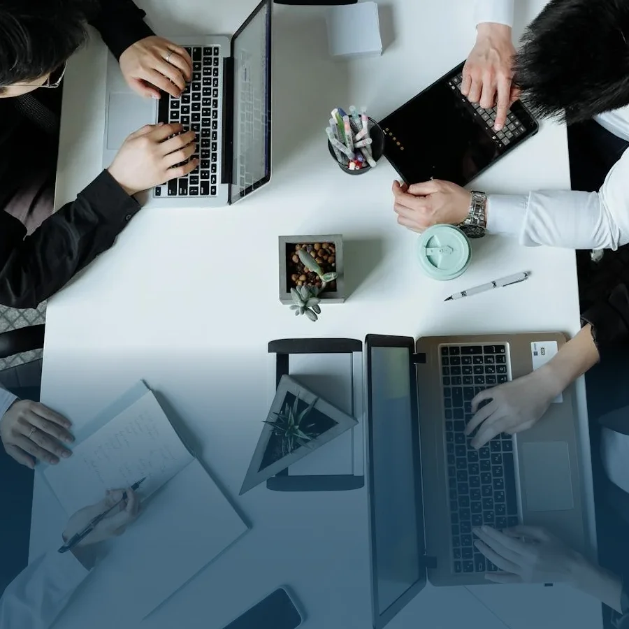 Employees on their work devices.