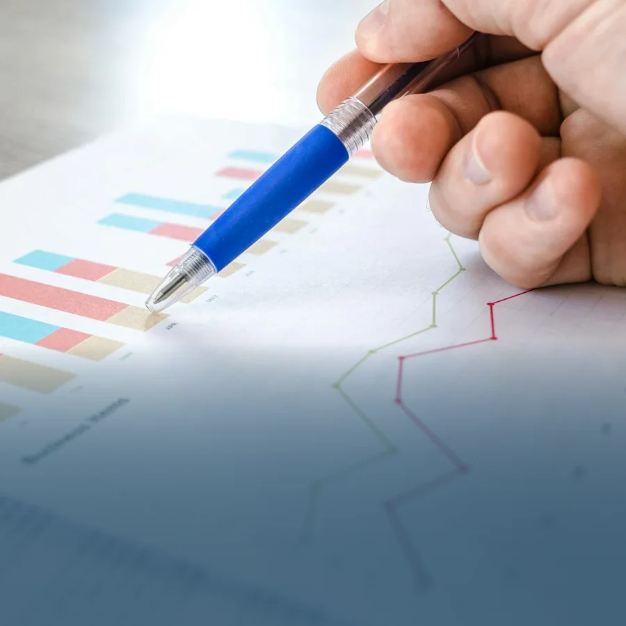 A close-up shot of a hand pointing towards changes in a budgets graph.