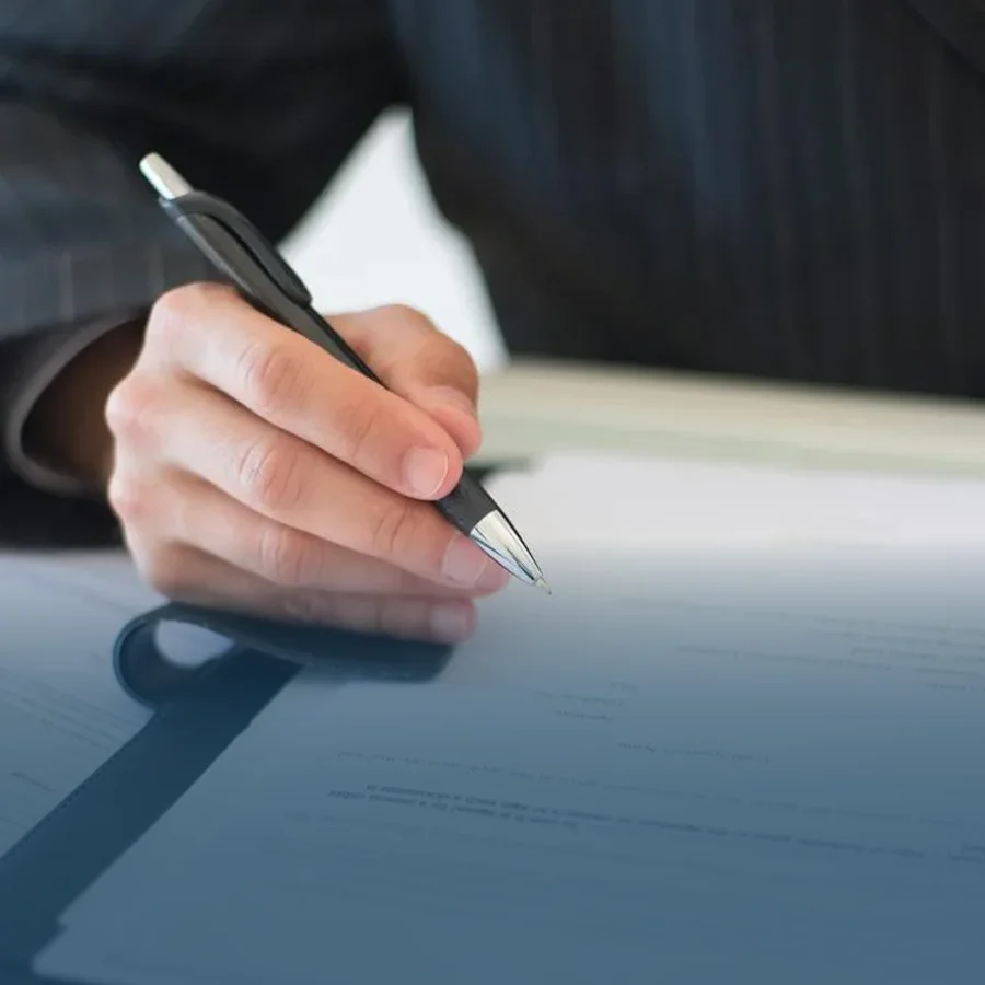 Signing a deal or statement.