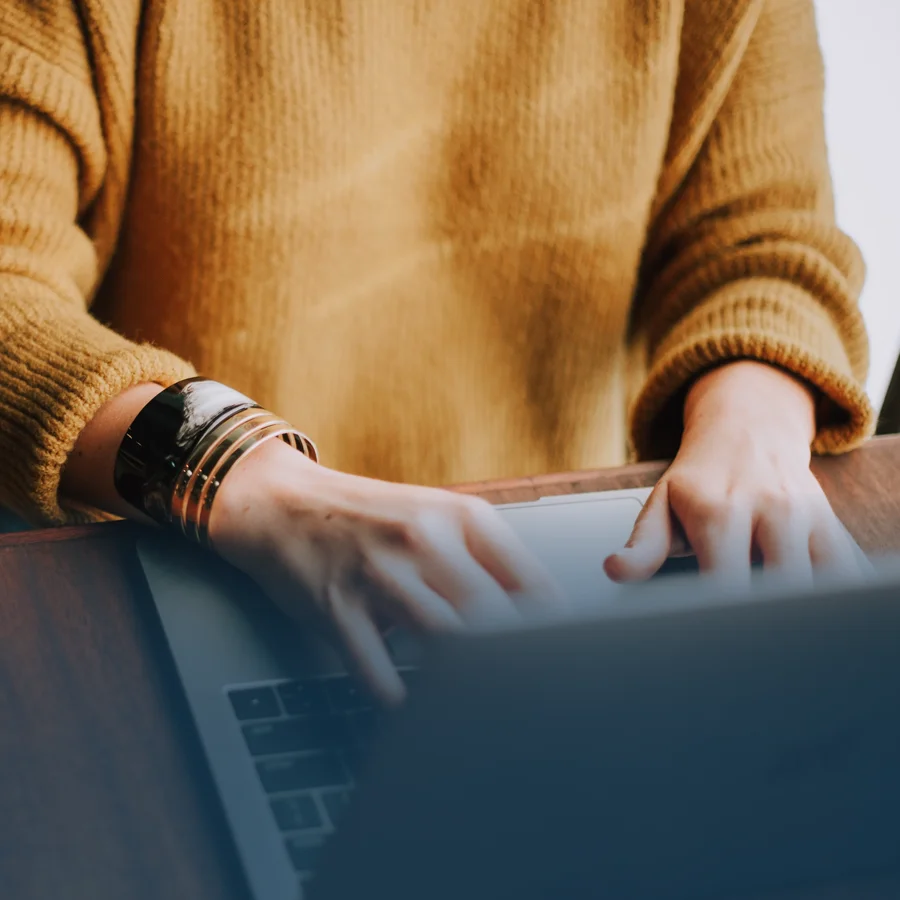 An employee typing on her laptop.